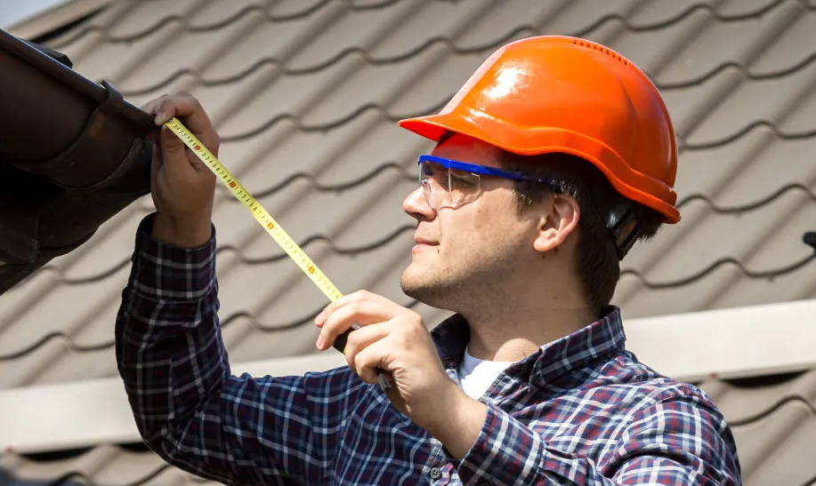 Roofing Contractor inspects a metal roof